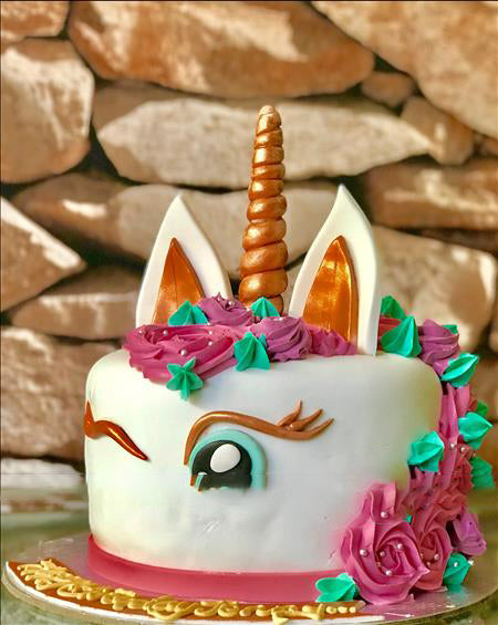 Premium Photo | A pink unicorn shaped cake with a hole in it